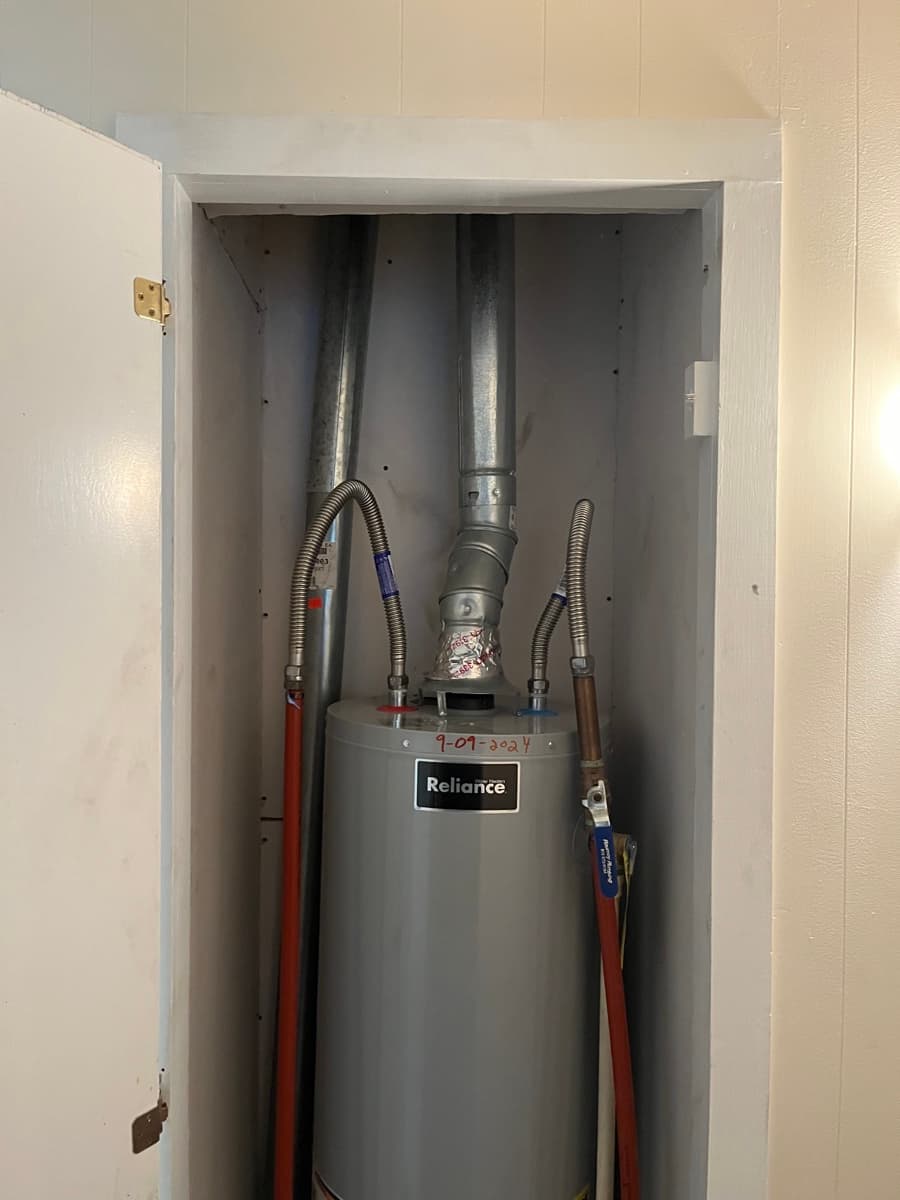 Installed residential water heater and connected plumbing lines
